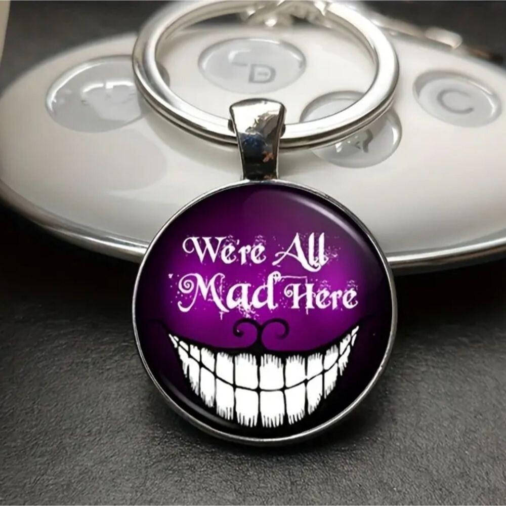 Cheshire cat we are all mad glow in the dark keychain